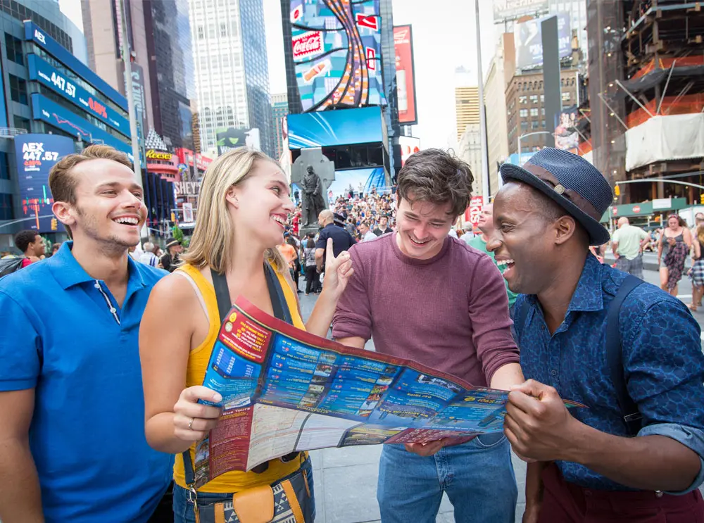 friends-looking-at-big-bus-tours-leaflet-in-times-square.webp